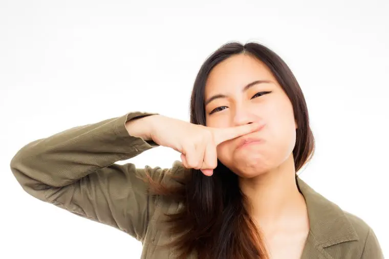 Asian Girl with finger under nose