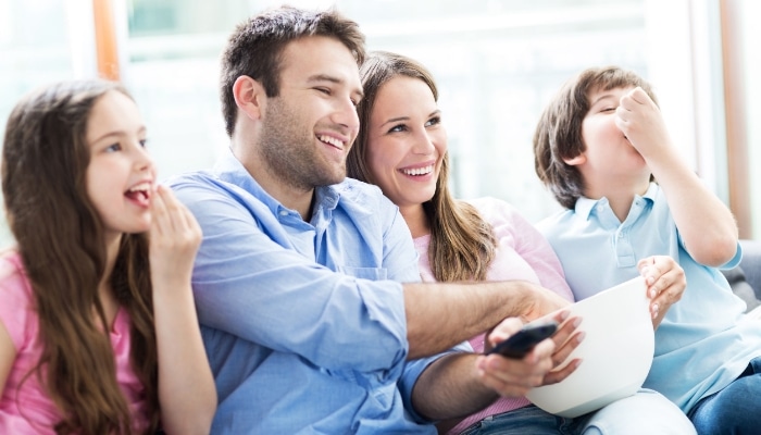 Family Comfort Watching Movie With Popcorn